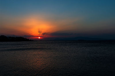 Scenic view of sea against romantic sky at sunset