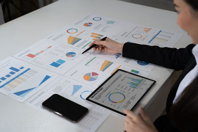 Cropped image of business colleagues working on table