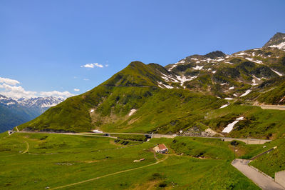 Scenic view of mountains against blue sky