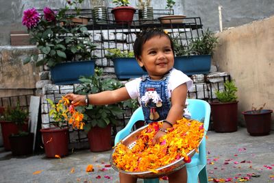 Portrait of cute boy in flower pot