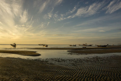 Scenic view of beach against sky during sunset