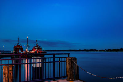 Pier over sea against blue sky