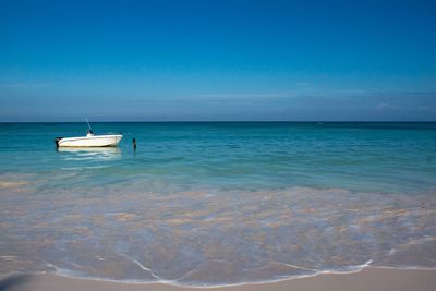 Boats in sea against sky