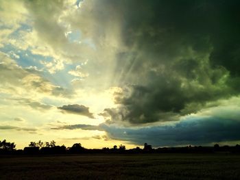 Scenic view of field against sky during sunset
