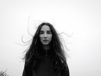 Portrait of beautiful young woman over white background