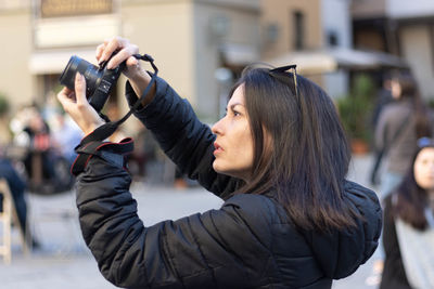 Portrait of photographer woman unfocused background at florence, italy. 50mm lens