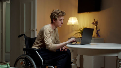 Young man using laptop at home