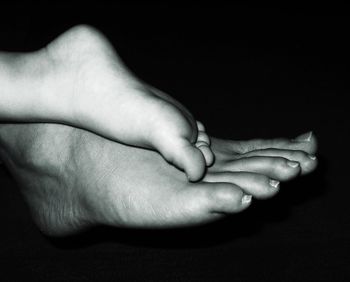 Close-up of hand holding over black background