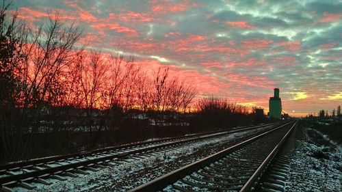 Railroad track passing through snow covered landscape