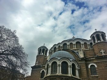 Low angle view of church against cloudy sky