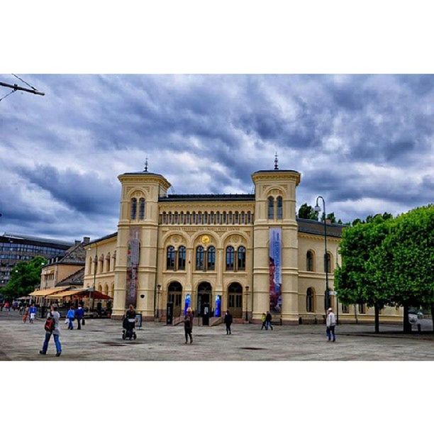 architecture, built structure, building exterior, sky, large group of people, famous place, travel destinations, cloud - sky, tourism, history, tourist, travel, international landmark, person, facade, men, arch, architectural column, capital cities