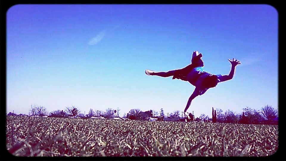 transfer print, clear sky, auto post production filter, copy space, blue, lifestyles, leisure activity, arms raised, enjoyment, full length, fun, men, mid-air, sky, low angle view, person, outdoors, vignette