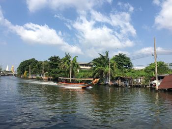 Boats in canal against sky