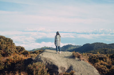 Full length of woman standing on landscape