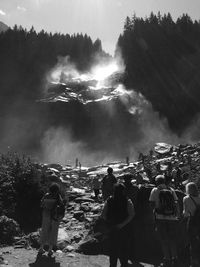 Rear view of people on mountain against sky