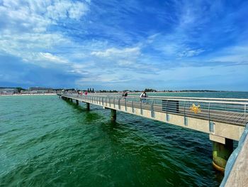 Pier over sea against sky