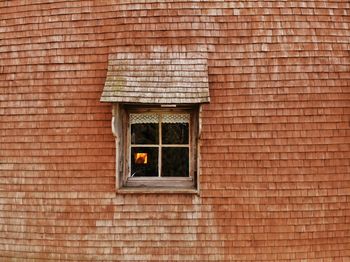 Low angle view of window on wall of building