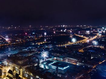 High angle view of city lit up at night