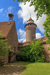 Low angle view of bell tower against sky