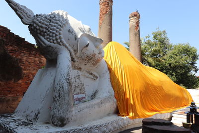 Statue of temple against building