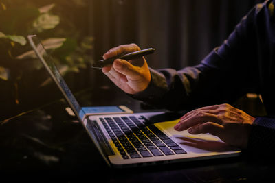 Midsection of man using laptop