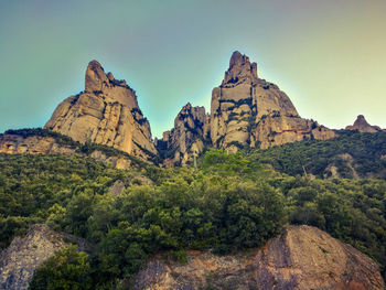 Rock formations on landscape against sky