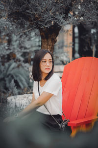 Portrait of young woman holding umbrella