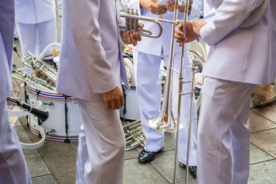 Musicians with equipment standing on footpath