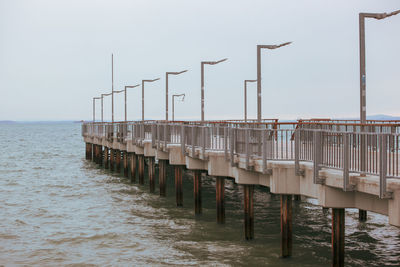 Pier on sea against clear sky