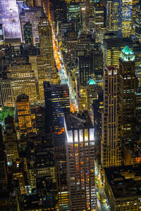 Aerial view of illuminated buildings in city at night