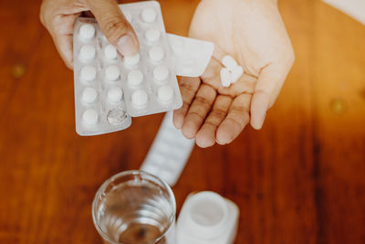 Midsection of man holding medicines