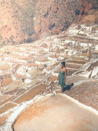 High angle view of woman standing on mountain