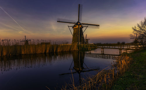 Windmill against sky during sunset