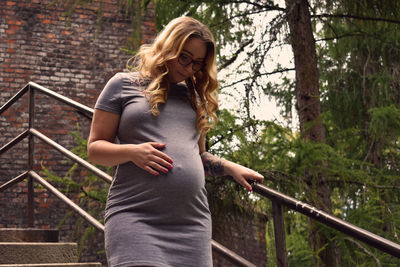Pregnant woman walking down steps outdoors
