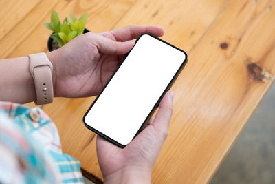 Midsection of person using mobile phone