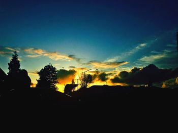 Silhouette trees against sky during sunset