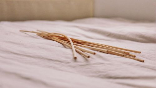 Close-up of sticks on bed at home