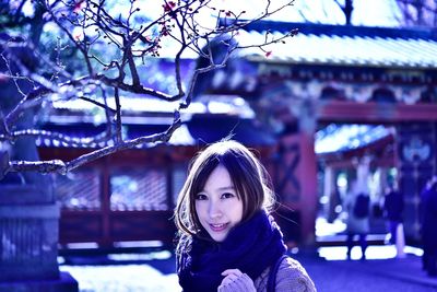 Portrait of smiling young woman standing outdoors