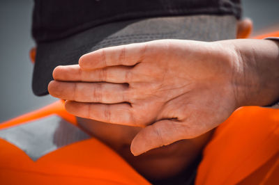 Close-up of boy holding in life jacket 