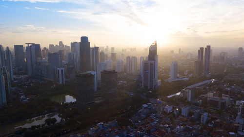 High angle view of buildings in city against sky during sunset