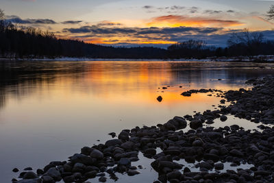 Scenic view of lake against sky during sunset