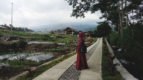 Woman in traditional clothing standing outdoors