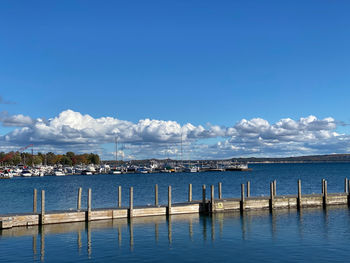 Sailboats in sea against blue sky