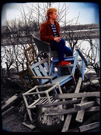 Full length of woman standing by railing