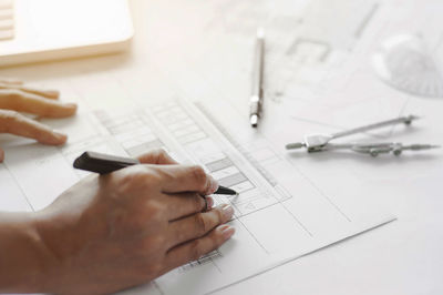 Midsection of man working on table