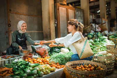 Portrait of smiling couple standing at market