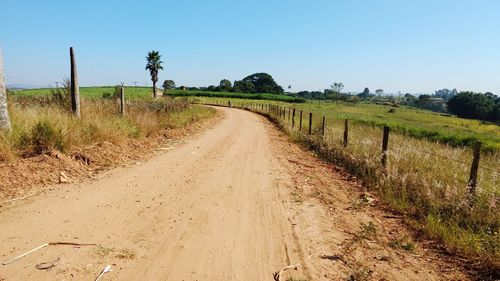 Dirt road along countryside landscape