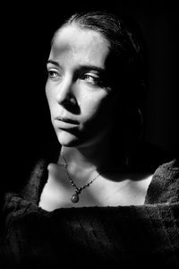 Portrait of young woman looking away