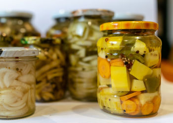 Close-up of coins in jars on table