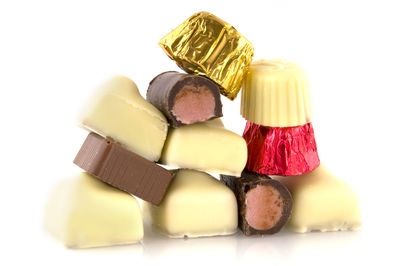 Close-up of candies against white background